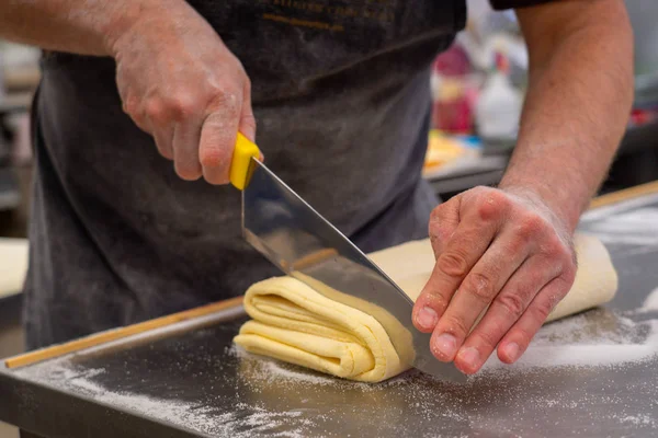 confectioner works the puff pastry dough, artisan, gourmet