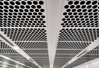 white perforated ceiling with black holes