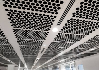 white perforated ceiling with black holes