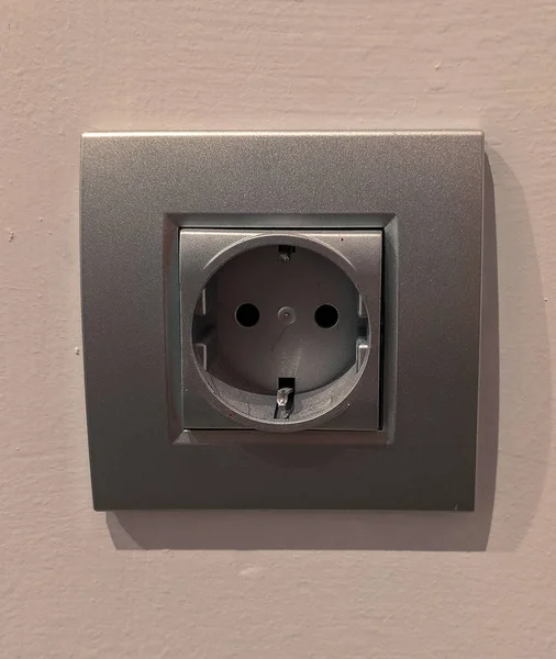 a light grey wall socket. European-type socket