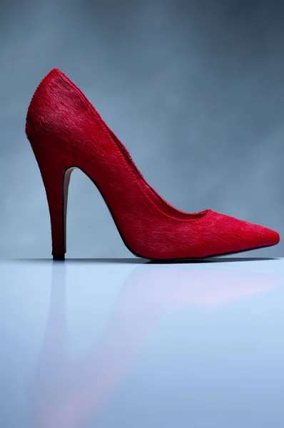 Red high heels isolated on grey background