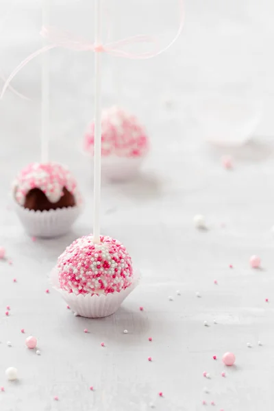 white and pink cake pops in mason jar