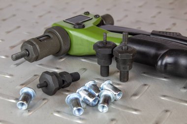 Çelik oyma perçinlerinin montajı için el aleti, sürükleyici ve değiştirilebilir başlıklar.