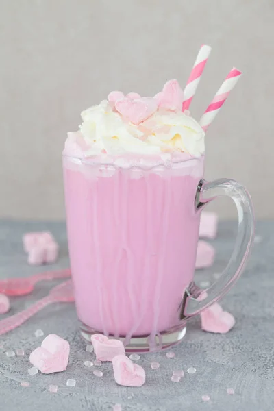 Pink hot chocolate / milkshake with whipped cream and marshmallows