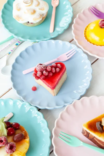 Delicious little cakes and pies on colorful plates