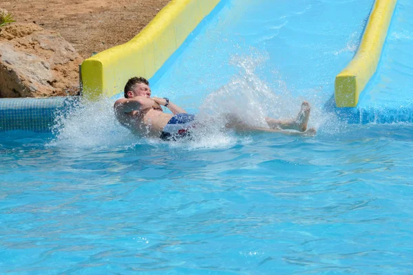 Young Man Ride Slide Water Park Stock Photo