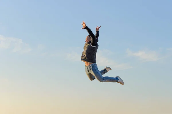 young man in a jump against a blue sky