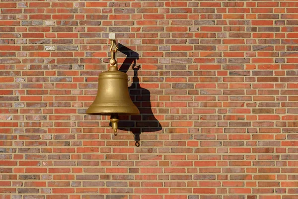 Bell hanging on a brick wall — Φωτογραφία Αρχείου