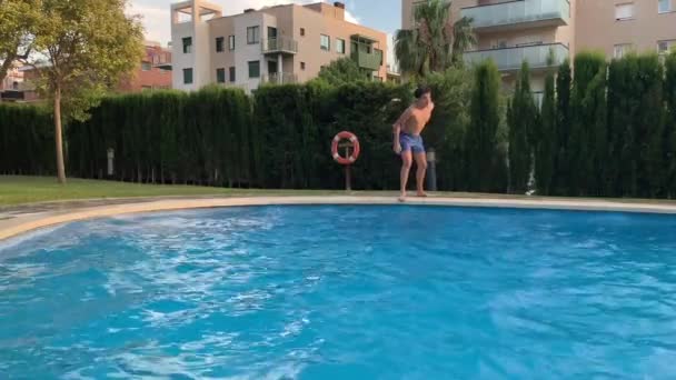 boy catches the ball jumping into the pool 4k slow motion