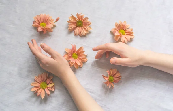 Hands of a beautiful woman on a white background. Delicate palm with natural manicure, clean skin. Light white nails. Hand Care