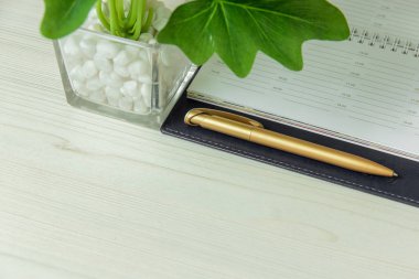 Ofis işyeri defter ve pot bitki ile yakın çekim.