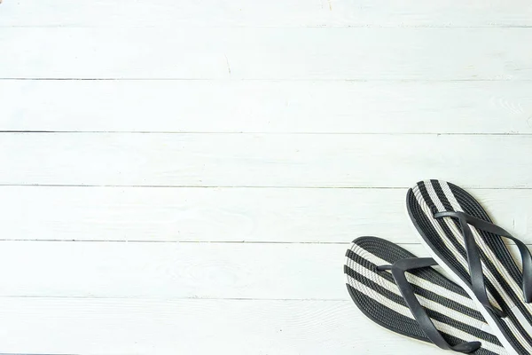 Frame elegant female slippers on white wooden background, copyspace for text, summer vacation. — Stock Photo, Image