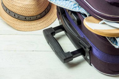 İle açık bavul seyahat aksesuarları boşaltmak Beyaz ahşap tablo.