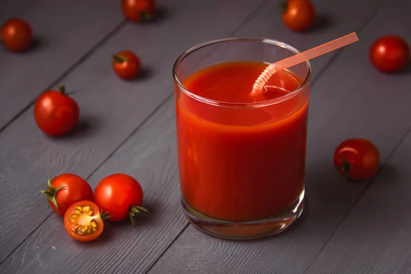 Tomatensaft in Gläsern auf grauem Holztisch. — Stockfoto