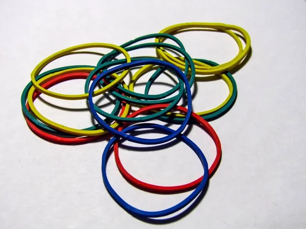 Colored elastic rubber bands on white background. photo