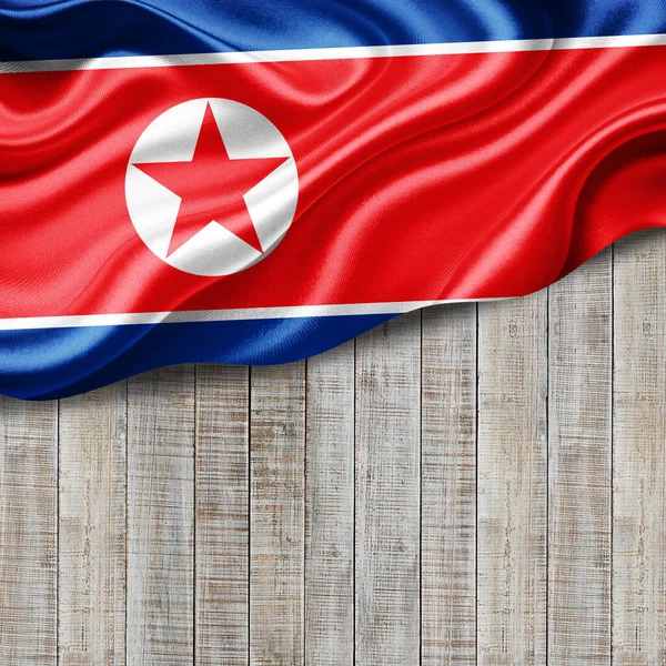 North Korea flag of silk with copyspace for your text or images and wood background-3D illustration