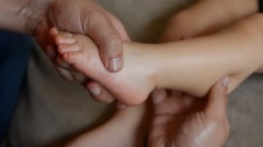 Erkek masaj terapisti bir yaşındaki erkek çocuk rehabilitasyon kurtarma masajı için bir beyin dolaşım bozukluğu, beyin inme, sağ taraflı hemiparez acı sonra yok.