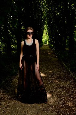 Genç çekici kadın seksi şeffaf siyah elbiseyi giyiyor. Genç kadın modern portre.