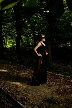 Genç çekici kadın seksi şeffaf siyah elbiseyi giyiyor. Genç kadın modern portre.