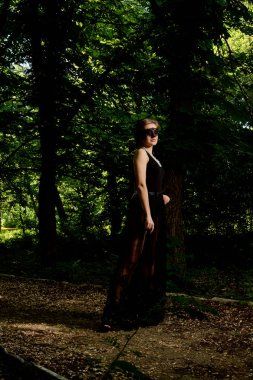 Genç çekici kadın seksi şeffaf siyah elbiseyi giyiyor. Genç kadın modern portre.