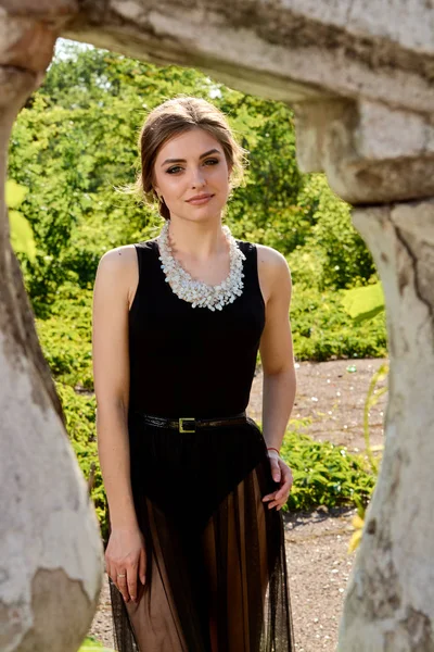 Young attractive woman in the sexy transparent black dress. Young woman portrait.