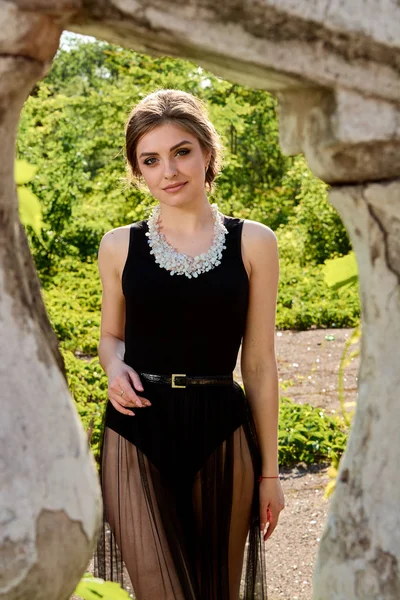 Young attractive woman in the sexy transparent black dress. Young woman portrait.