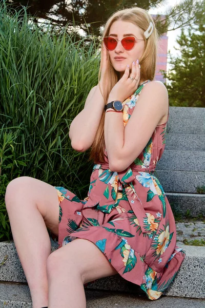 Jovem mulher atraente. Óculos de sol vermelhos, vestido a cores. Retrato de mulher jovem . — Fotografia de Stock