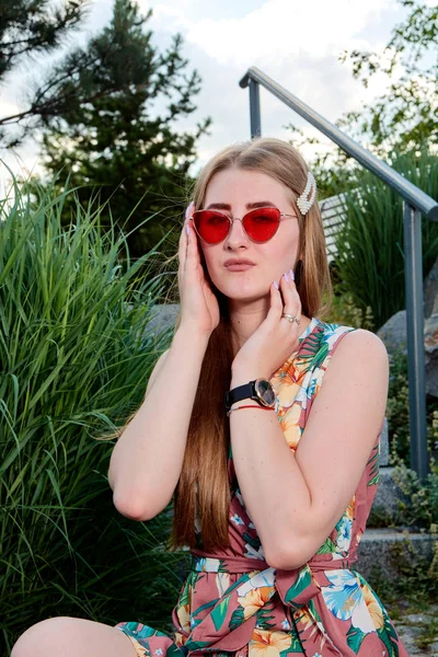 Jovem mulher atraente. Óculos de sol vermelhos, vestido a cores. Retrato de mulher jovem . — Fotografia de Stock