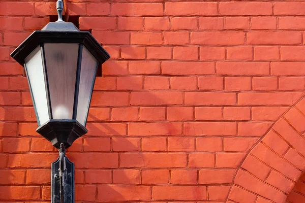 Forged lantern on a red brick wall with  space for lettering or design — Stock Photo, Image