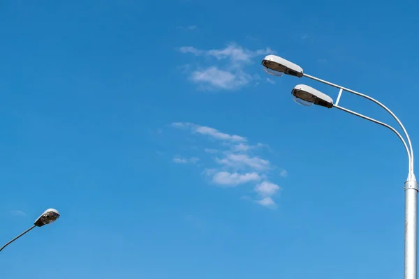 Street lights against the blue sky with clouds. Copy space. — Stock Photo, Image