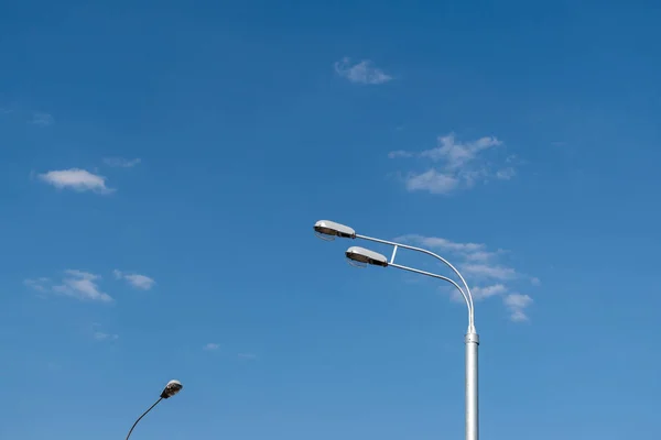 Street lights against the blue sky with clouds. Copy space. — Stock Photo, Image