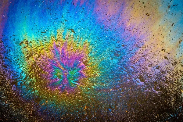 Colored oil stain on the asphalt. A rainbow slick of gasoline. A