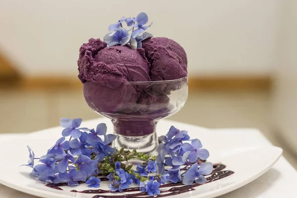 Deep purple ice cream scoops decorated with fancy flowers