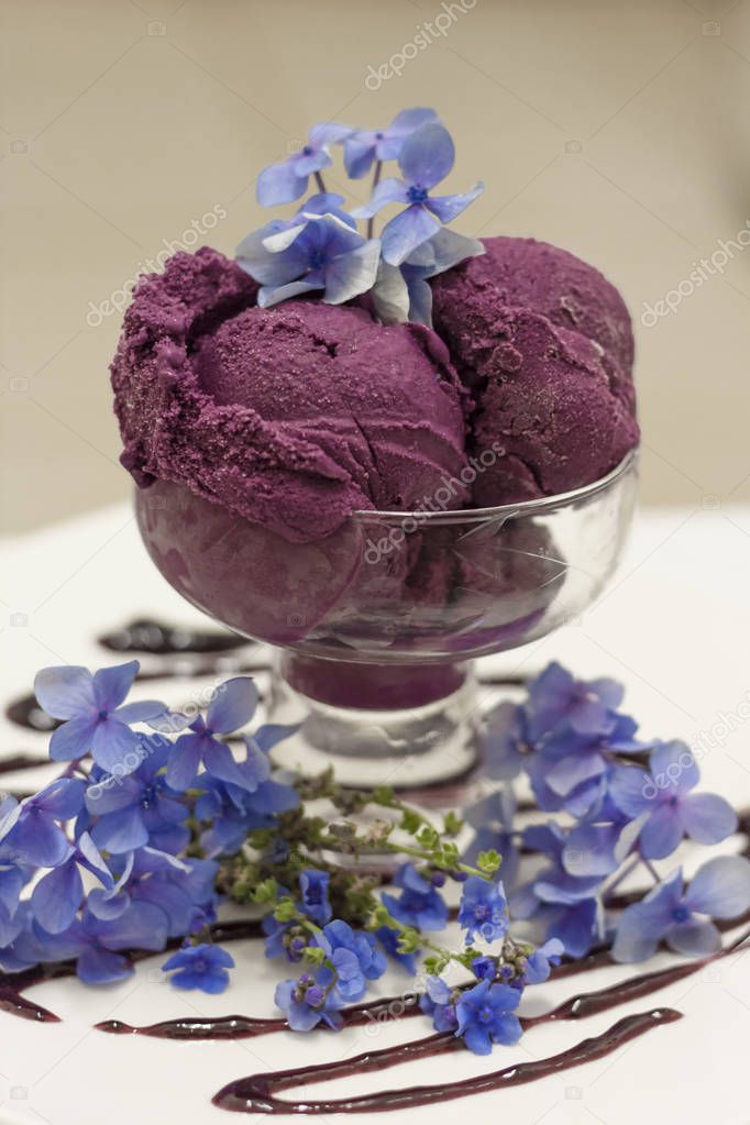 Deep purple ice cream scoops decorated with fancy flowers 45 degree view