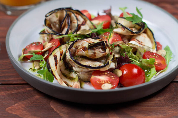 Grilled eggplant salad, tomatoes, lettuce with olive oil and red balsamic, sea salt and pink pepper. Vegan health food