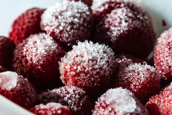 Frozen strawberries. Storage of frozen food. Freezing berries. Frozen foods.Strawberry in frost close-up macro.