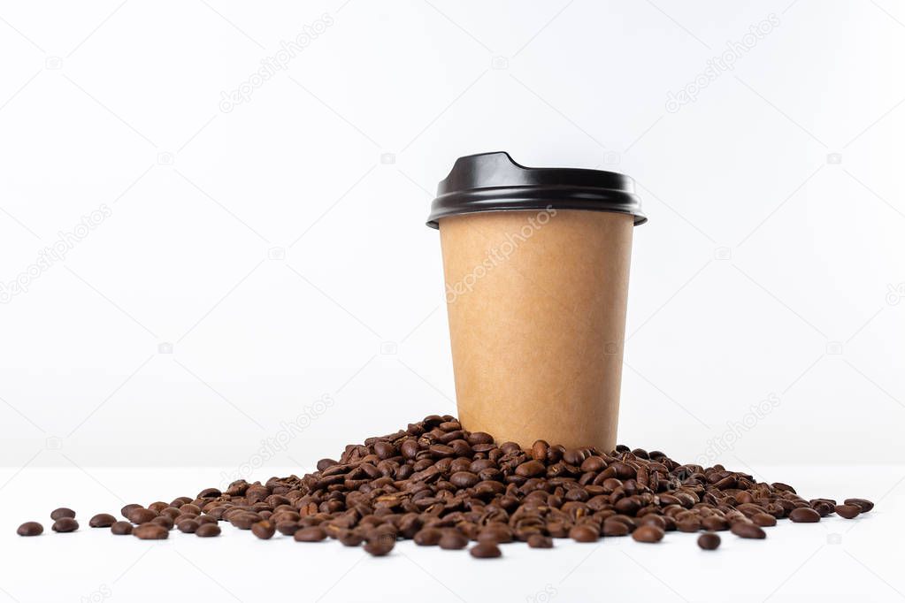 Craft coffee cup and coffee beans on white background