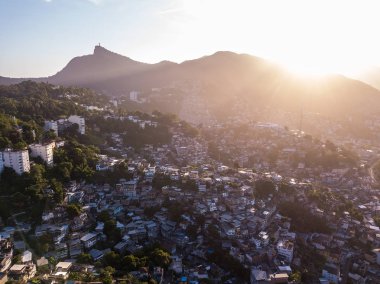 Sunset in Rio de Janeiro Brazil. Aerial photo to houses on hills and mountains. Beautiful sunset backlight. Evening in favela clipart