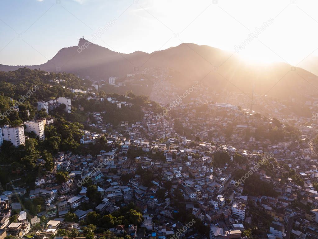 Sunset in Rio de Janeiro Brazil. Aerial photo to houses on hills and mountains. Beautiful sunset backlight. Evening in favela