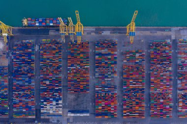 Aerial view to a lot of intermodal shipping container are in a port. cargo transportation system on ships. Graphic view of multi-colored containers on top. equipment and cranes clipart