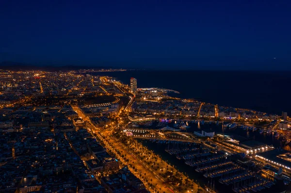 Aerial Night photo of port with yachts, Barceloneta beach, center of Barcelona and road with car traffic. Aerial view drone pictures. Spain Catalonia at night — Stock Photo, Image
