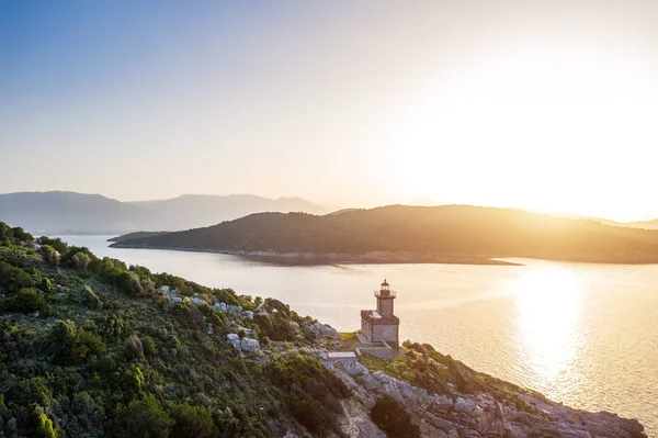 Poros aéreos Grécia Farol de Dana. Luz de fundo do pôr do sol. Ilhas gregas em segundo plano. Foto de luz dourada mágica. Drone aéreo foto — Fotografia de Stock