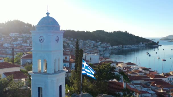 Poros île de Grèce. Eglise sur la colline. Développer romantique le drapeau national. Images aériennes — Video