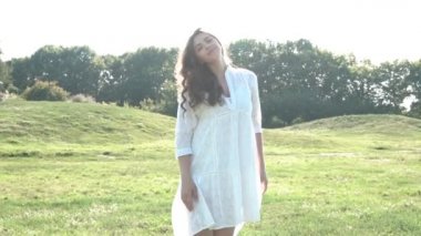 Doğa yeşili arka planda mutlu rahat kadın. Boho tarzı elbise. Video görüntüleri