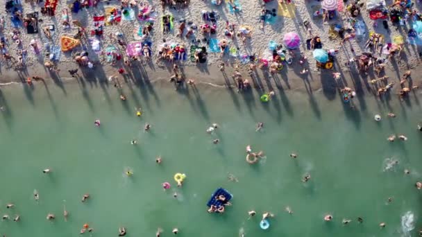 混雑したビーチバケーションのトップビュー ビーチで夏の波を楽しんでいます 上記の異常な視点からの元の空中ドローン芸術創造的な組成物 オデッサウクライナ黒海リゾートビデオ映像 — ストック動画