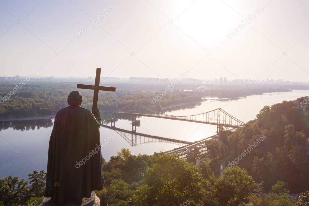 Kyiv Ukraine. Monument to St. Volodymyr of Kiev view to Dnipro river Parkovy Pedestrian and Bicycle Bridge. cross symbol christianity orthodox. blesses the city at dawn. panoramic beautiful historic 