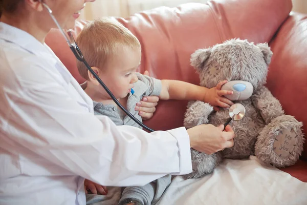 Doctor and boy child playing with stethoscope