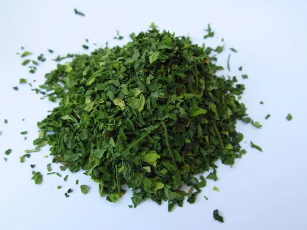Dried green parsley spice on a white background