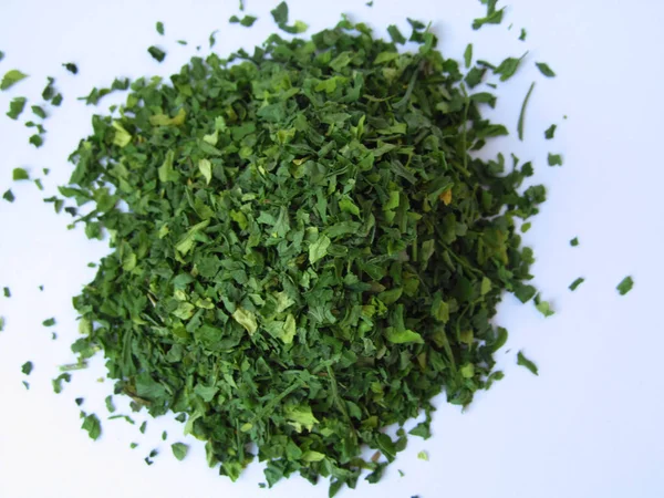 Dried green parsley spice on a white background