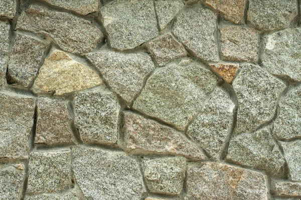 Prachtige texturale stenen achtergrond, een hek gemaakt van steen, stenen textuur — Stockfoto